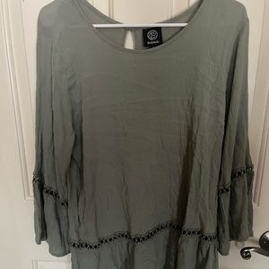 long/half sleeve dark green flowy shirt with design at the bottom